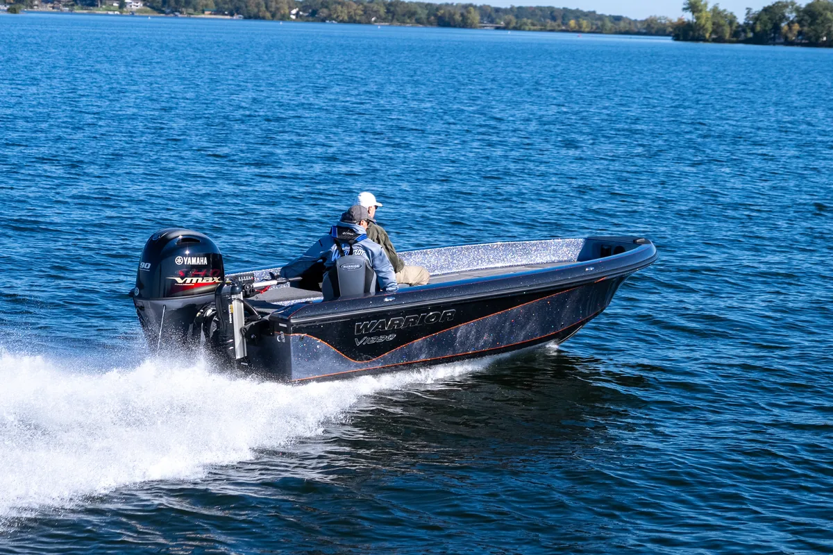 Warrior V1890 tiller running to the right across open water on a clear day